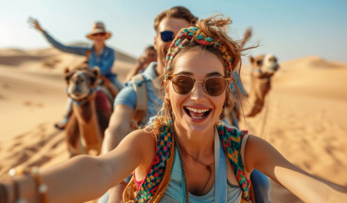 Guests enjoying camel ride in desert